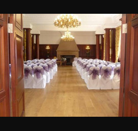 White Chair Covers and heather bows at Doxford Hall