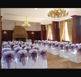 White Chair Covers and heather bows at Doxford Hall