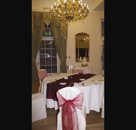 White Chair Covers and ruby red bows at Doxford Hall