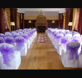 White Chair Covers and Purple bows at Doxford Hall