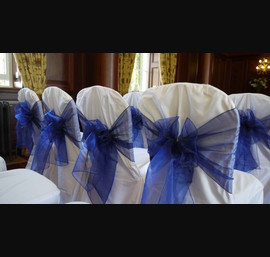 White Chair Covers and Midnight blue bows at Doxford Hall
