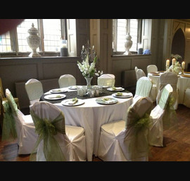 Willow sashes on white chair covers at Ellingham Hall