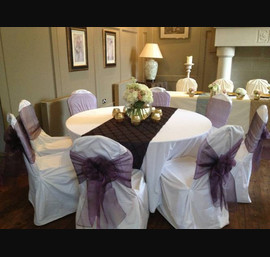Heather sashes on white chair covers at Ellingham Hall