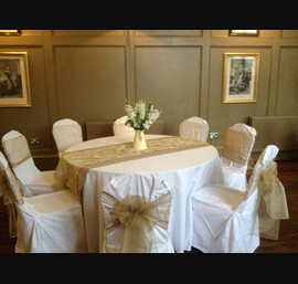 Champagne sashes on white chair covers at Ellingham Hall