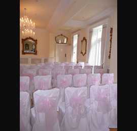 White Chair Covers and Baby Pink Bows at Eshott Hall