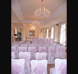 White Chair Covers and Baby Pink bows at Eshott Hall