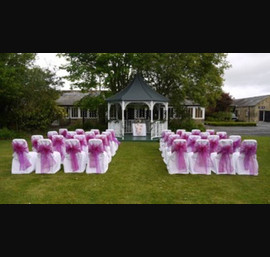 White Chair Covers and Raspberry Bows at Horton Grange's outdoor ceremony area