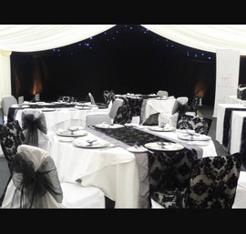 White Chair Covers and Black Bows and Black Flock Table Runner at Horton Grange