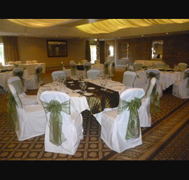 Willow sashes on white chair covers at Linden Hall