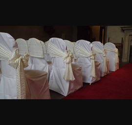 Butter Chair Covers and Lace caps and sashes tied on the side at Matfen Hall