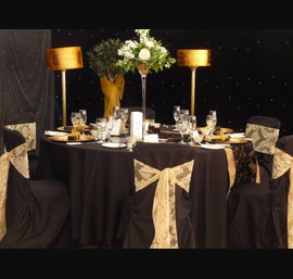 Black Chair Covers and gold Flock Sashes at Otterburn Hall