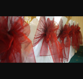 White Chair Covers and Ruby Bows at Otterburn Towers