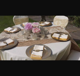 Buttermilk chair covers and table cloths, gold pin tuck taffeta table runner, gold flock organza runner over the top. Beautiful table centre designed and created by Adam Prest