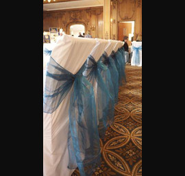 White Chair Covers and Peacock Blue Bows at The White Swan