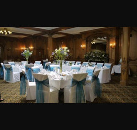 White Chair Covers and Peacock Blue Bows at The White Swan