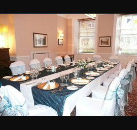 White Chair Covers and Peacock Blue Bows at The White Swan