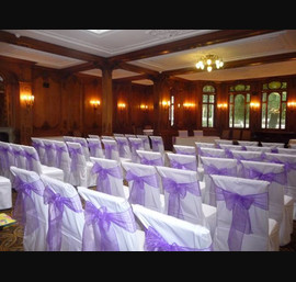 White Chair Covers and Purple bows at The White Swan