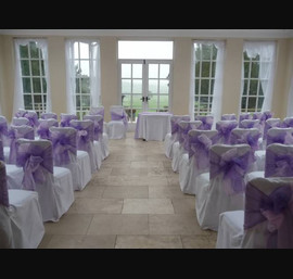 White Chair Covers and Pink & purple double bows at Wooodhill Hall