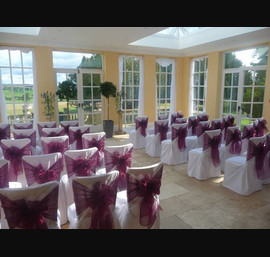 White covers with wine bow at Woodhill Hall